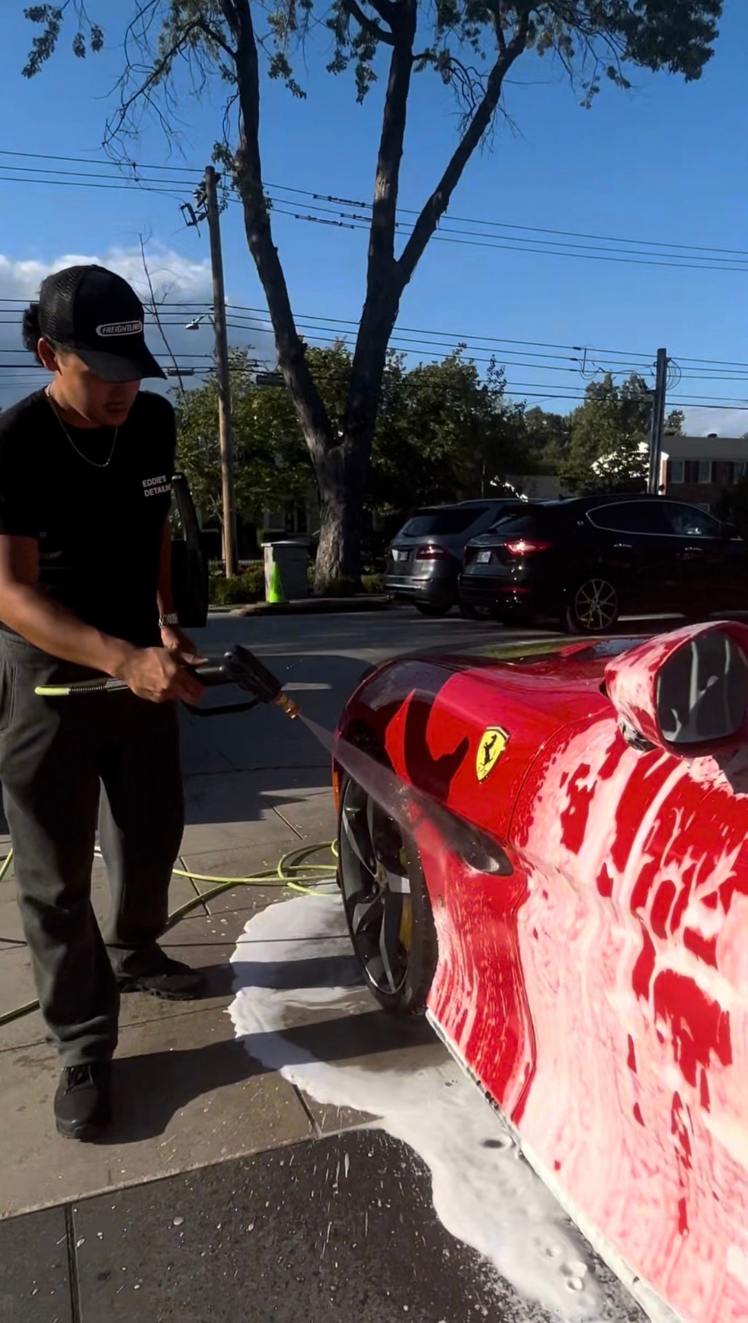 Mobile foam wash on a red sports car